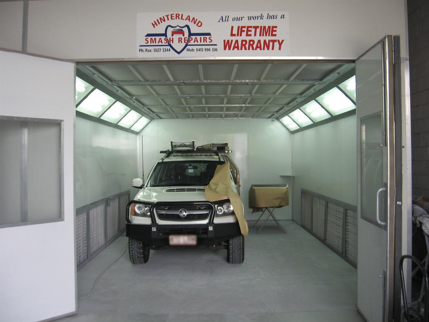 Four-wheel drive masked for paint inside the Hinterland Smash Repairs spray booth in Nerang